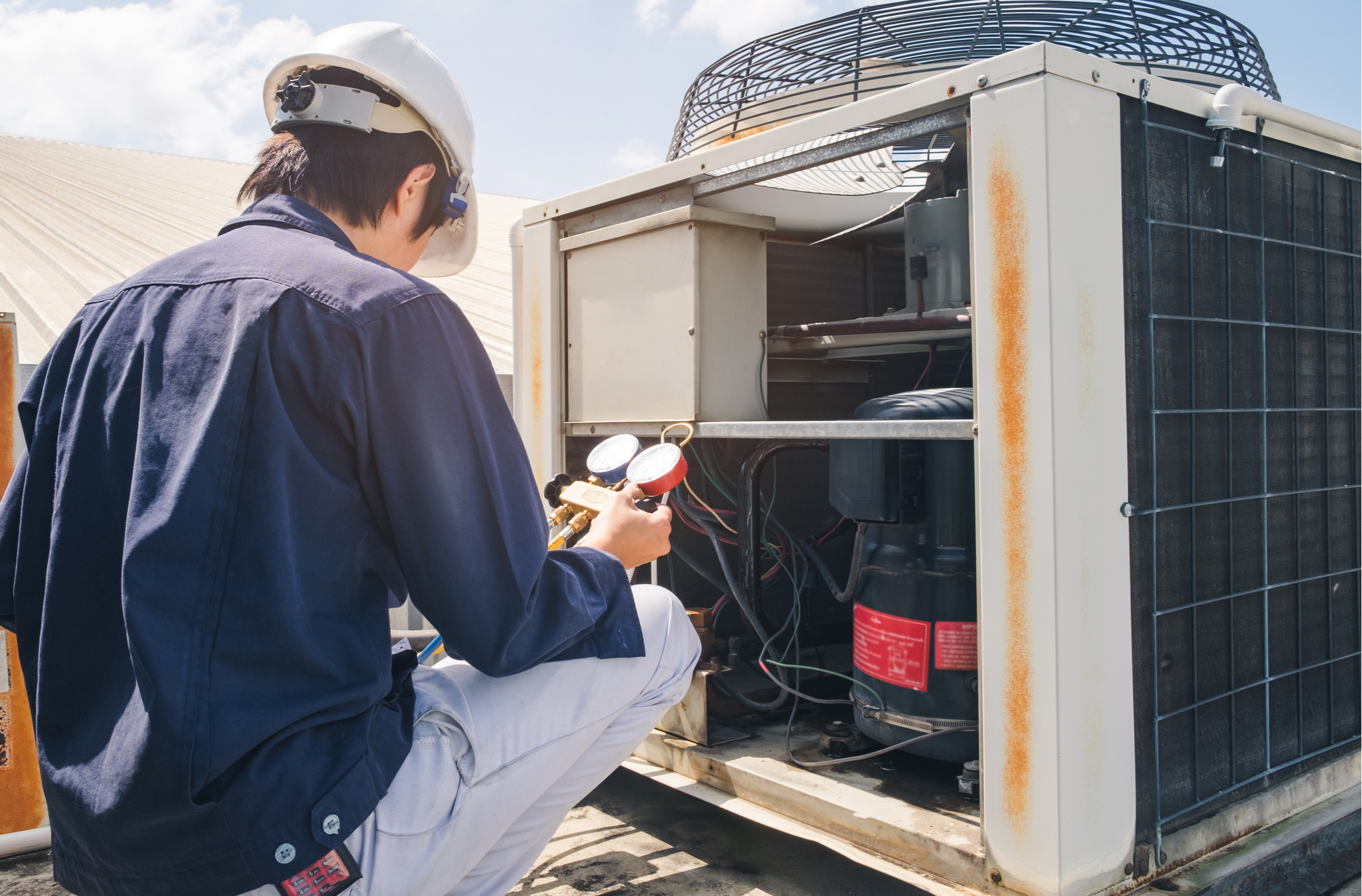 Technician working on air conditioner.
